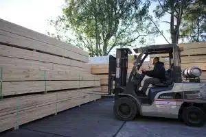 Timber bundle lifted by forklift